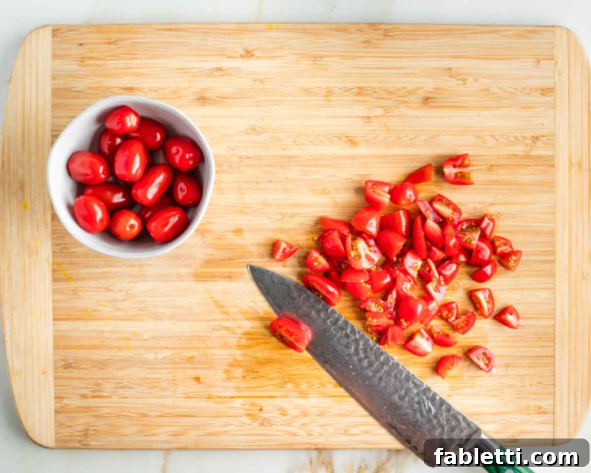 Smoky Shiitake and Zesty Russian Vegan Wedge 6 Close-up of cherry tomatoes being quartered in a small bowl, showcasing freshness.