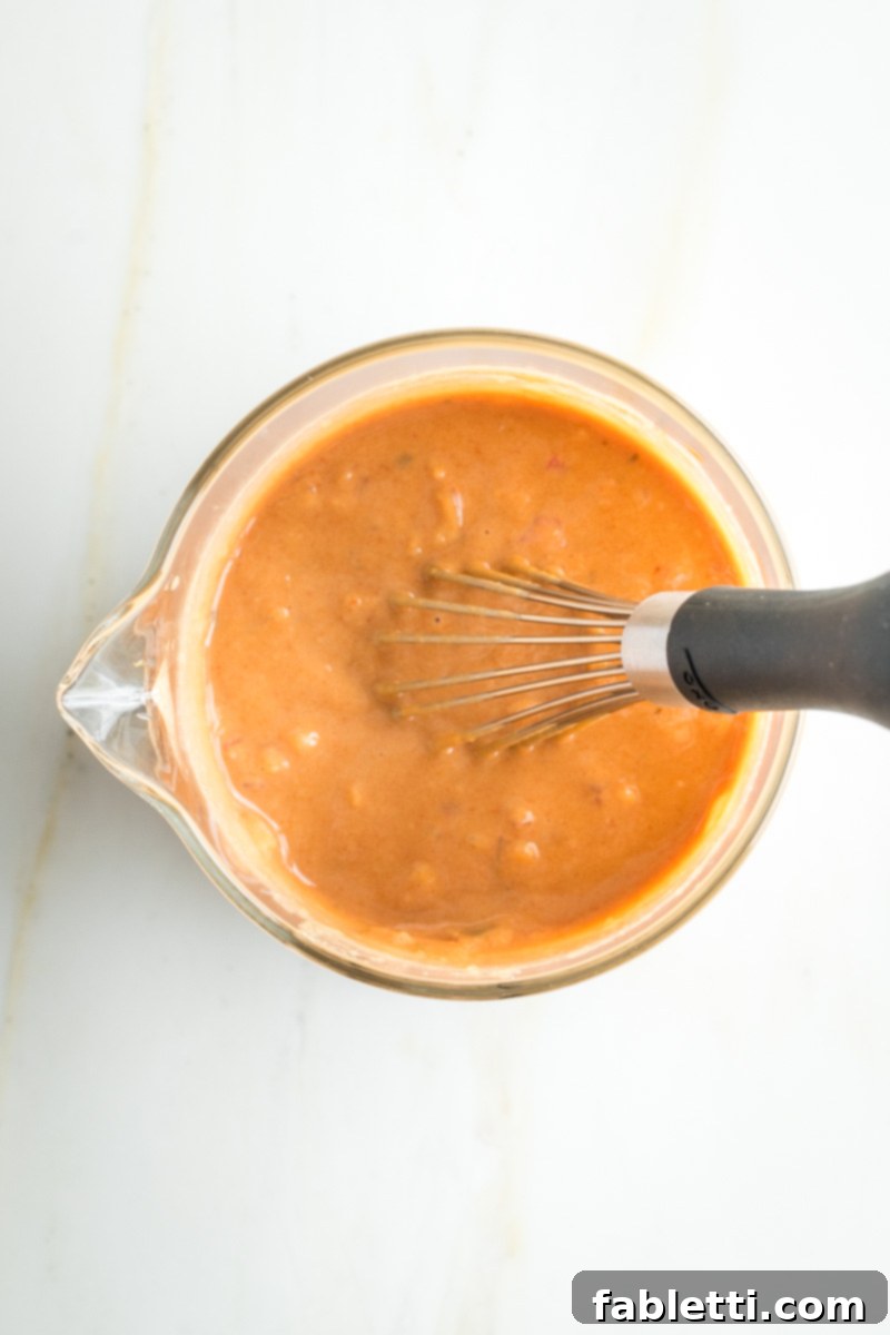 Smoky Shiitake and Zesty Russian Vegan Wedge 8 Whisking together the vibrant ingredients for the homemade Russian Dressing in a small bowl.