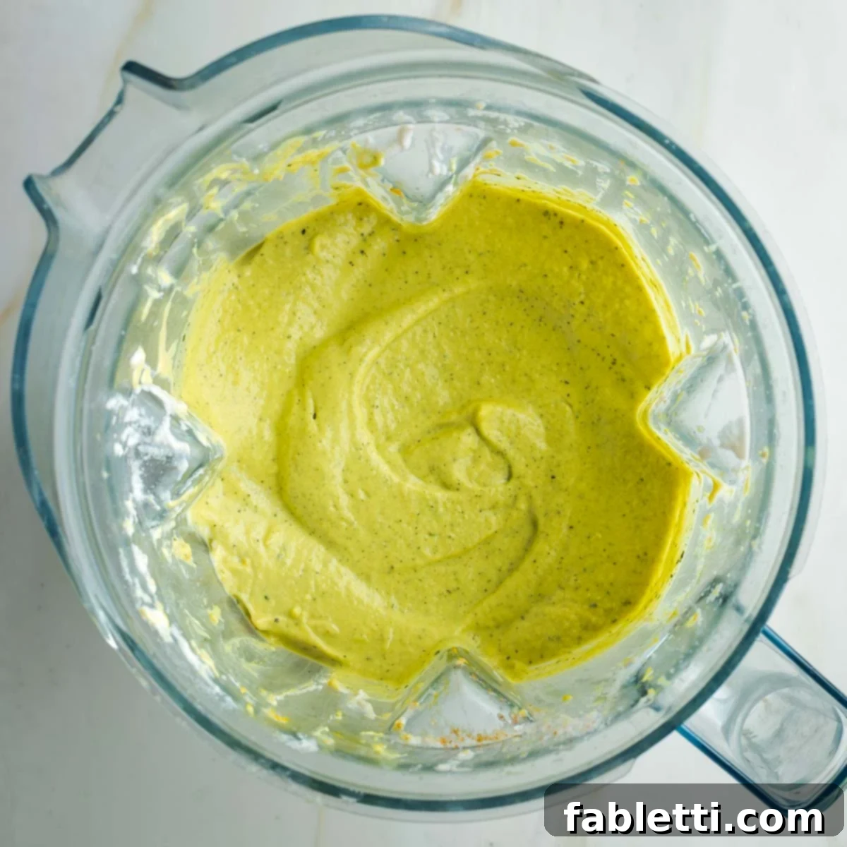 Caramelized Zucchini and Onion Creamy Dip 13 The finished thick and creamy, subtly green-hued dip within the pitcher of a blender, showcasing its smooth texture.