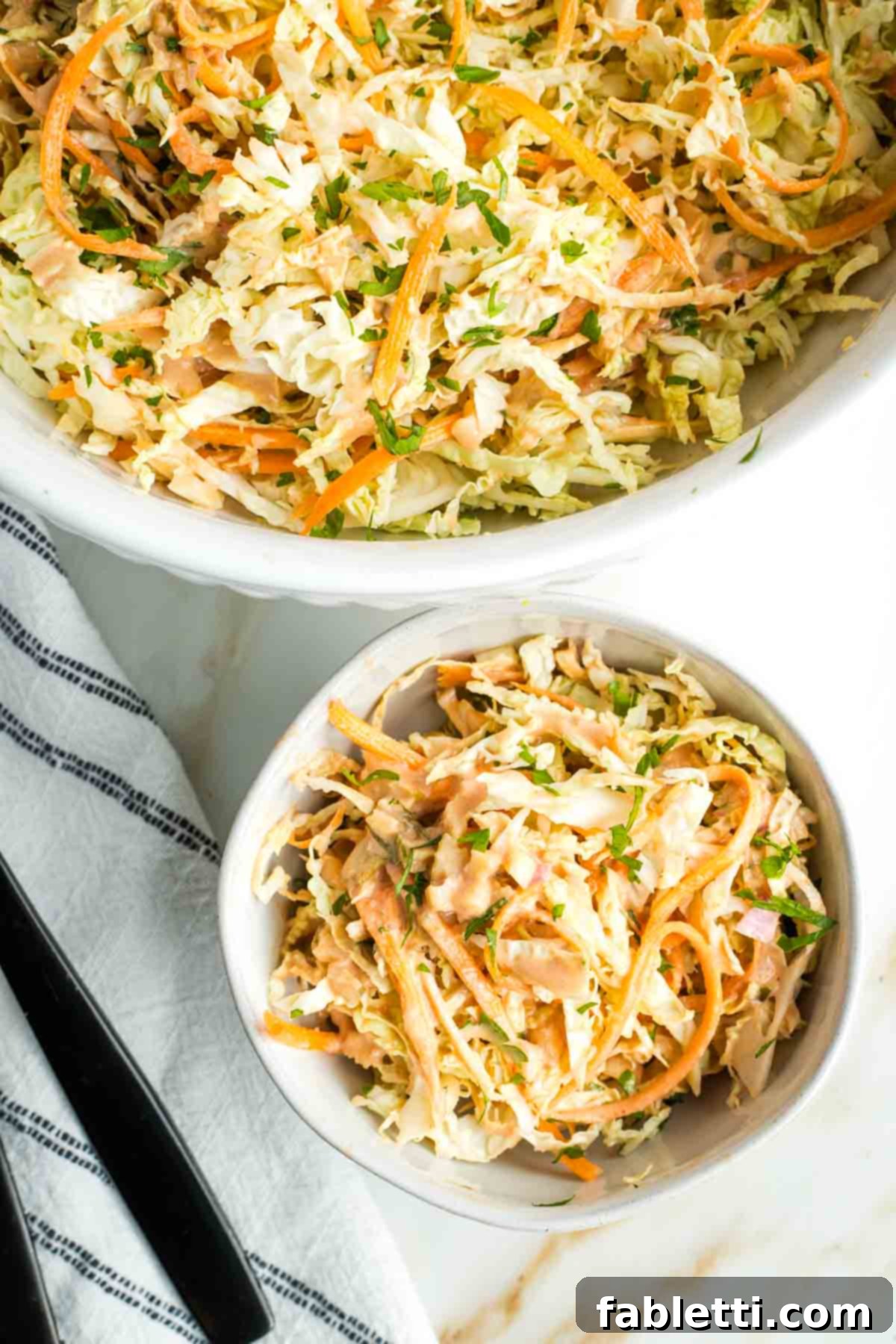 Shredded cabbage and carrots topped with fresh herbs and russian dressing.