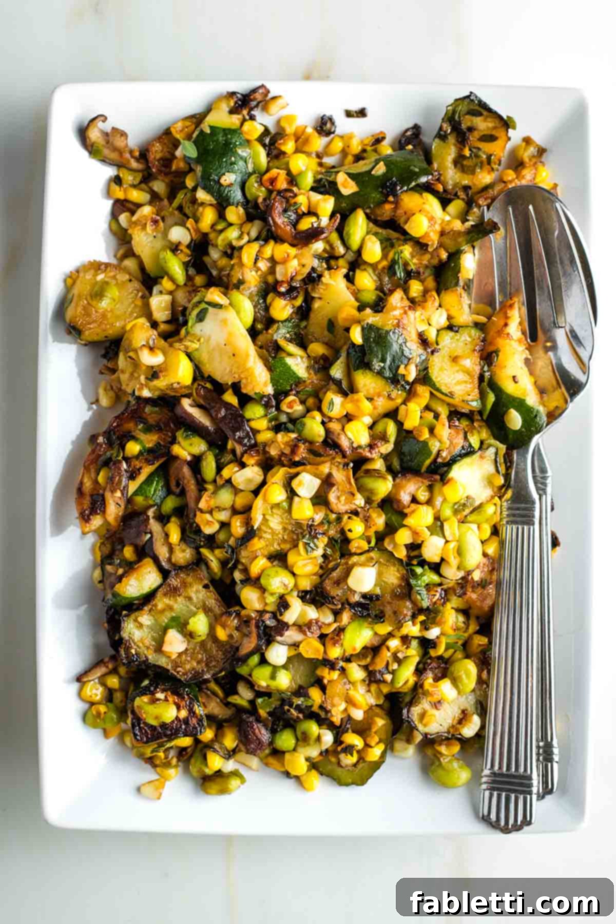 Vegan Zucchini Skillet Dinner in Just 20 Minutes 2 Charred zucchini and mushrooms with corn, onion and edamame. A vibrant and healthy vegan skillet dinner.