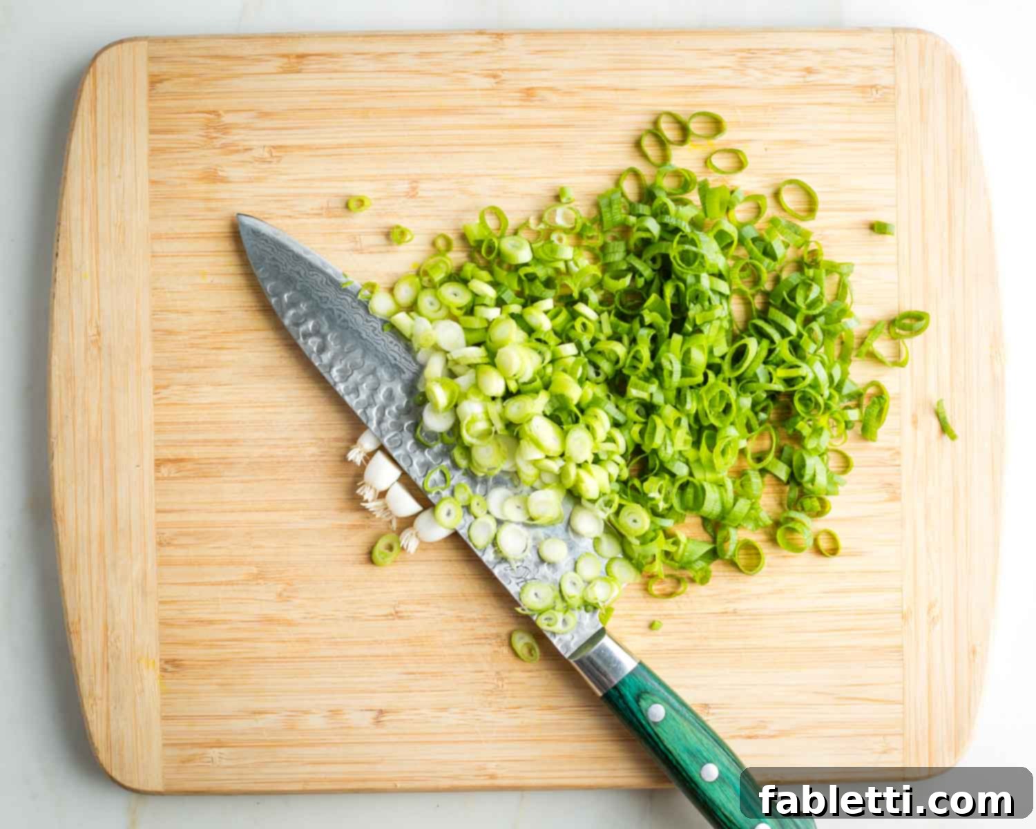 Vegan Zucchini Skillet Dinner in Just 20 Minutes 6 Thinly slicing white and green parts of the scallions.