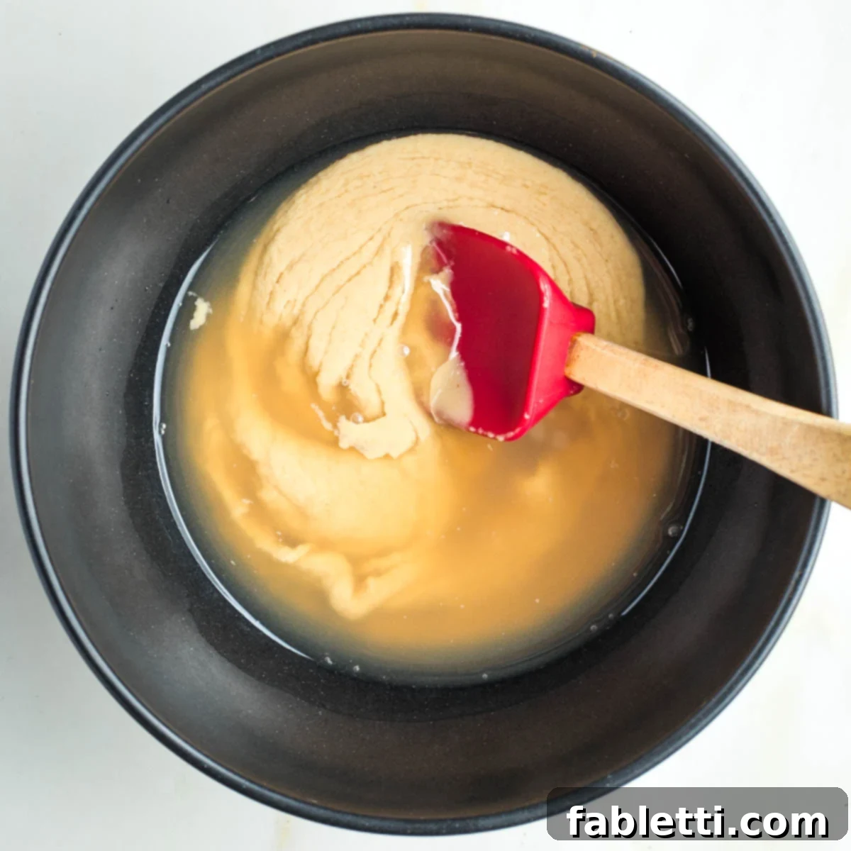 Zingy Vegan Tofu Egg Salad 11 Stirring water and lemon juice into tahini.