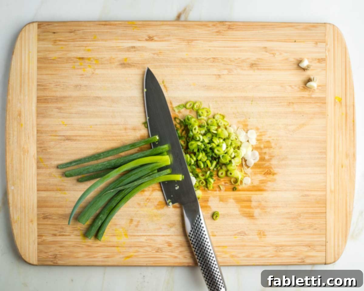 Zingy Vegan Tofu Egg Salad 5 Thinly slicing white and green parts of scallions.