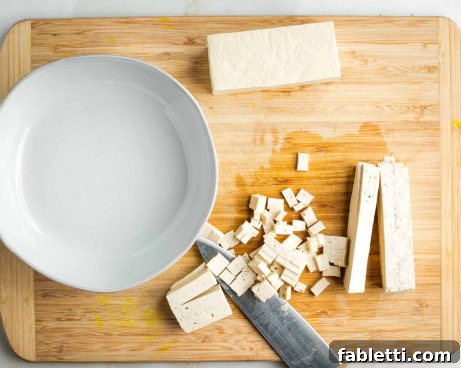 Zingy Vegan Tofu Egg Salad 9 Half a block of tofu cut into slices and then turned on its side to turn those into small diced cubes.