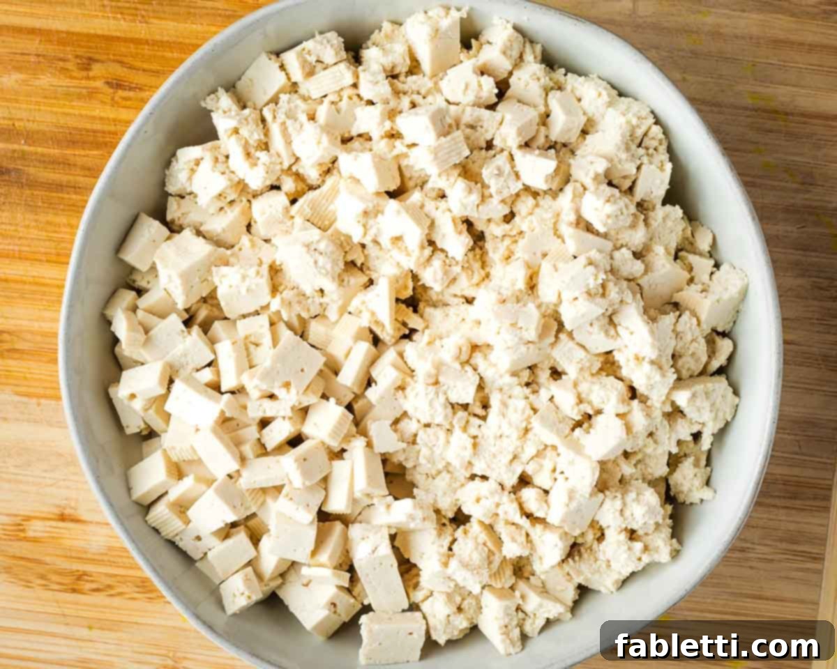 Zingy Vegan Tofu Egg Salad 10 Bowl of tofu, half roughly torn into small pieces and the other half cut into neat little cubes.