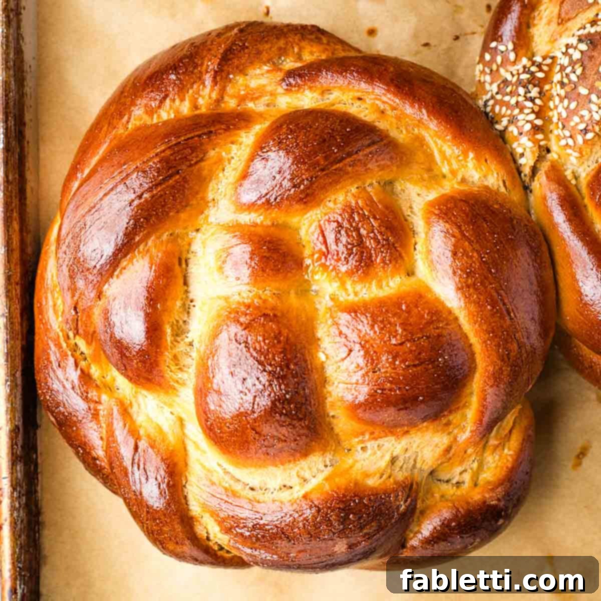 Pillowy Sweet Challah Crown 43 Golden brown, round braided loaf of challah.