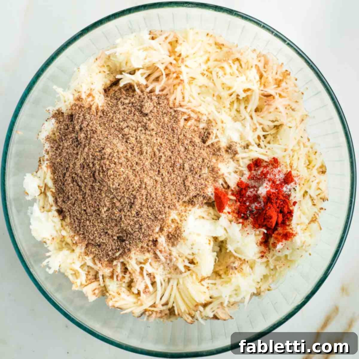 Ultimate Vegan Potato Kugel 10 Thinly shredded onions and potatoes, topped with ground flax, paprika, salt, and pepper.