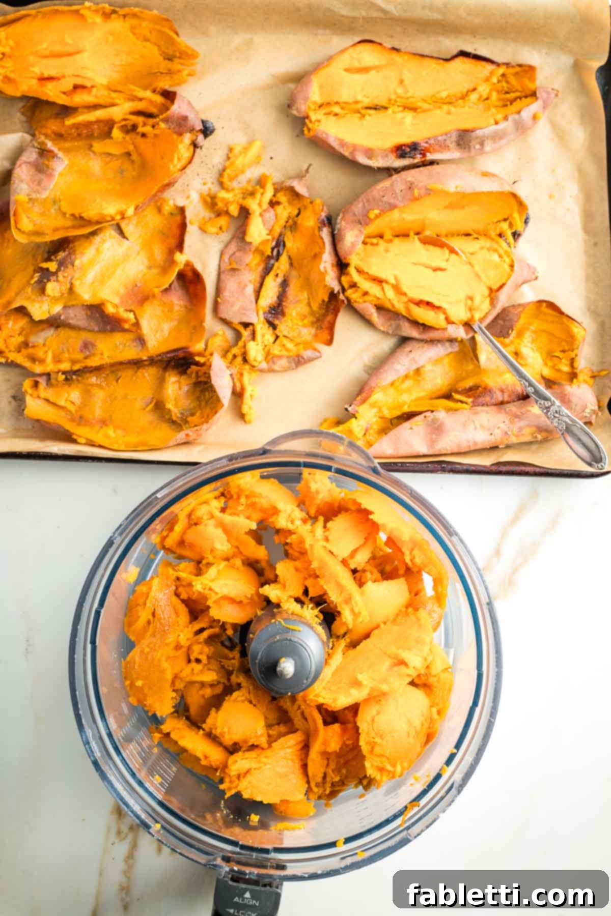 Golden Maple Pecan Sweet Potato Casserole 12 Tray of baked sweet potatoes with their pulp scooped out and placed into the bowl of a food processor for blending.