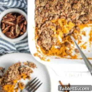 Golden Maple Pecan Sweet Potato Casserole 20 Sweet potato casserole with maple pecan topping, served beautifully on a plate, ready to be enjoyed.