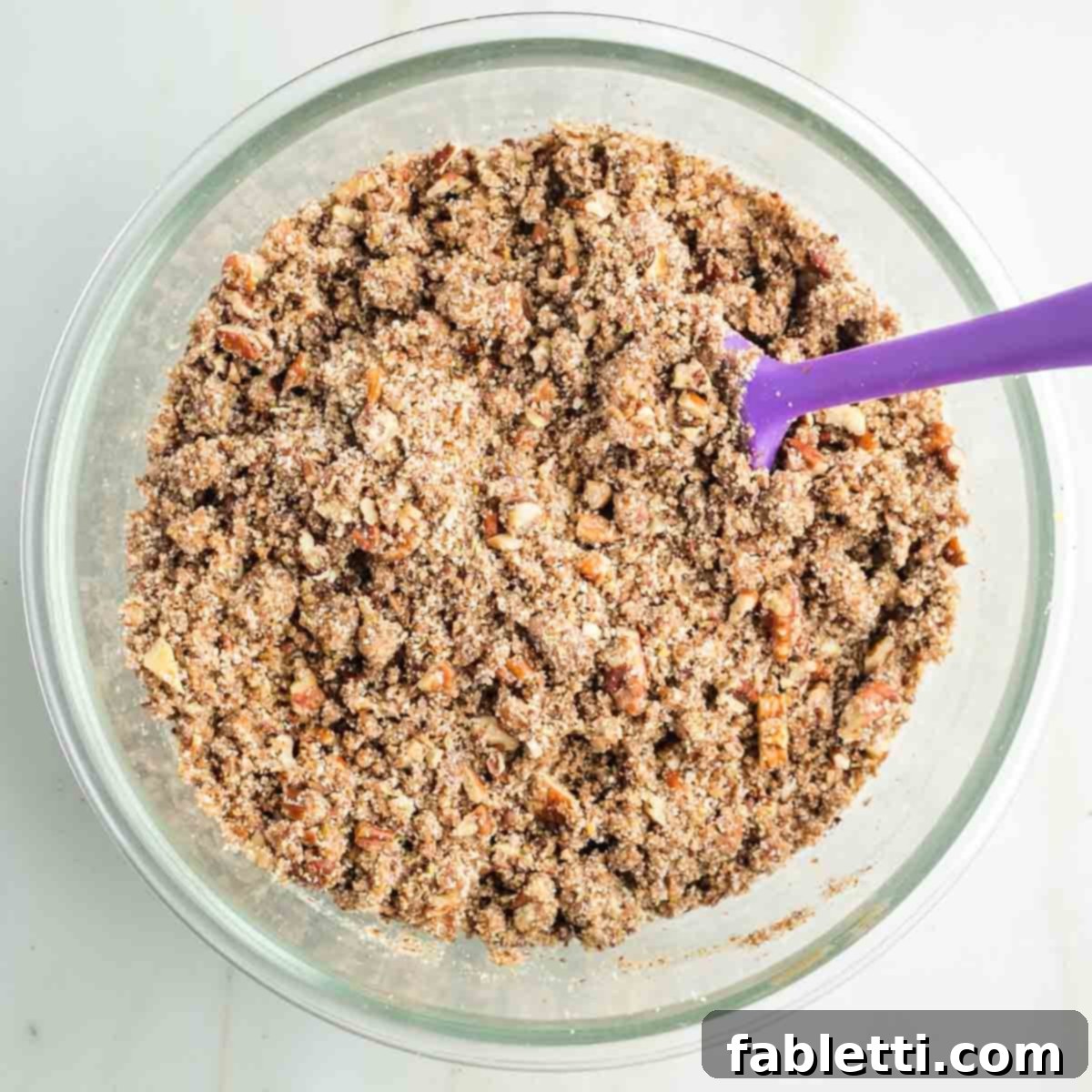 Golden Maple Pecan Sweet Potato Casserole 10 Crumbly maple pecan mixture, ready to be spread over the sweet potato casserole filling, showing the ideal texture.