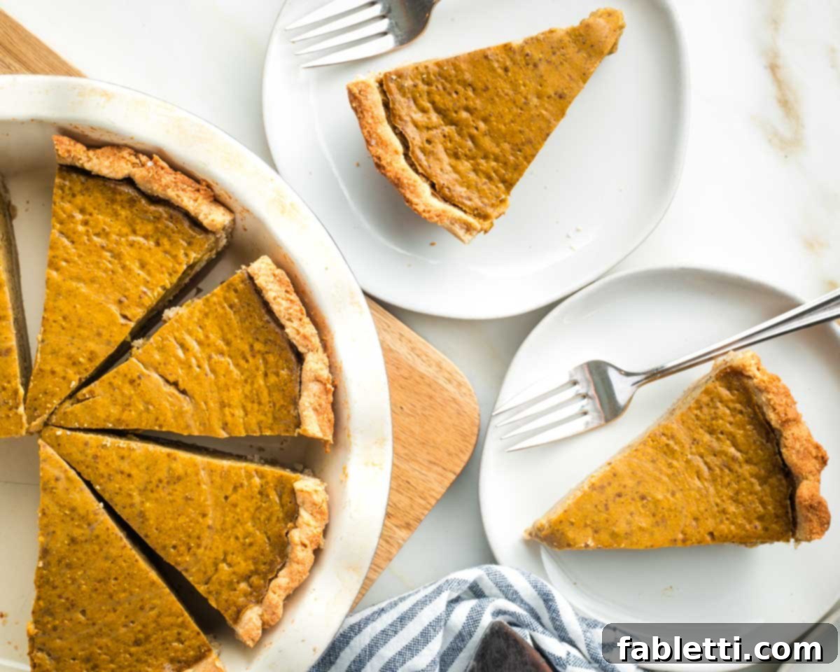 Effortless Vegan Pumpkin Pie with a Homemade Dairy-Free Crust 19 A close-up shot of a perfect slice of vegan pumpkin pie, showcasing its smooth, creamy filling and delicate crust.