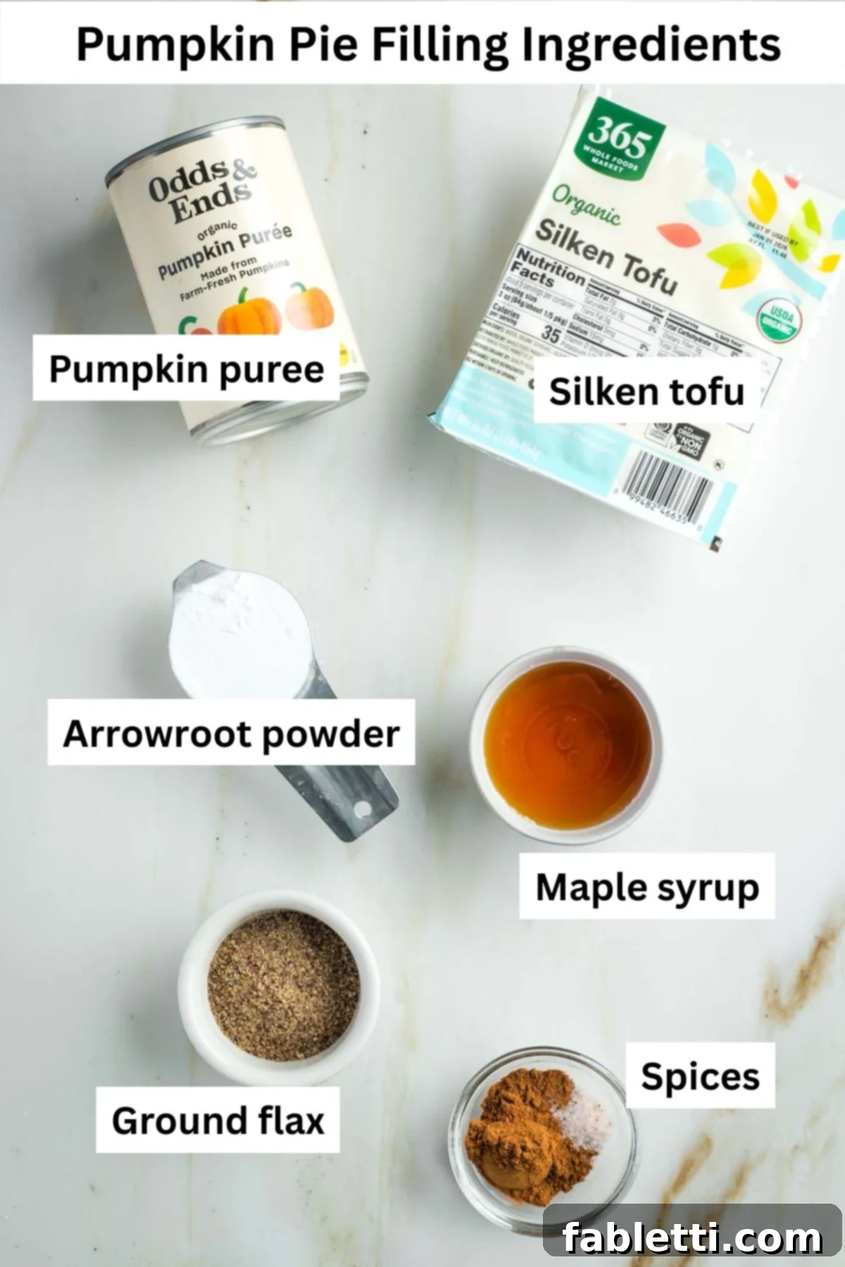 Effortless Vegan Pumpkin Pie with a Homemade Dairy-Free Crust 3 Labeled ingredients for the creamy vegan pumpkin pie filling: a can of pumpkin puree, a package of silken tofu, arrowroot powder, maple syrup, ground flaxseed, and an array of warming spices.