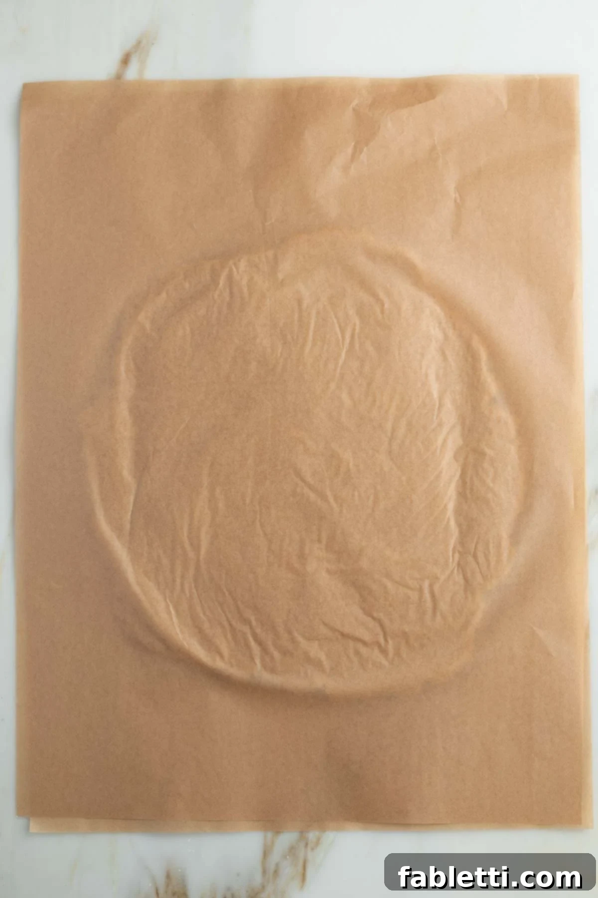 Effortless Vegan Pumpkin Pie with a Homemade Dairy-Free Crust 9 A second piece of parchment paper covers the vegan pie dough, which is being rolled into a large, thin circle.