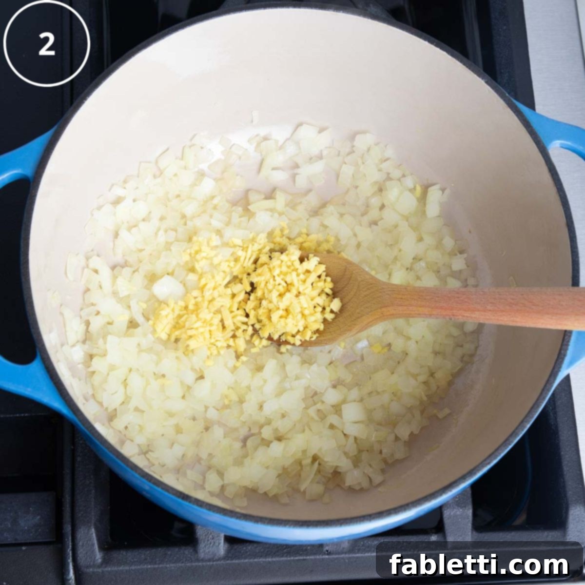 Golden Vegan Carrot Ginger Soup 9 Sautéed translucent onions are combined with freshly minced ginger in a Dutch oven, releasing fragrant aromas.