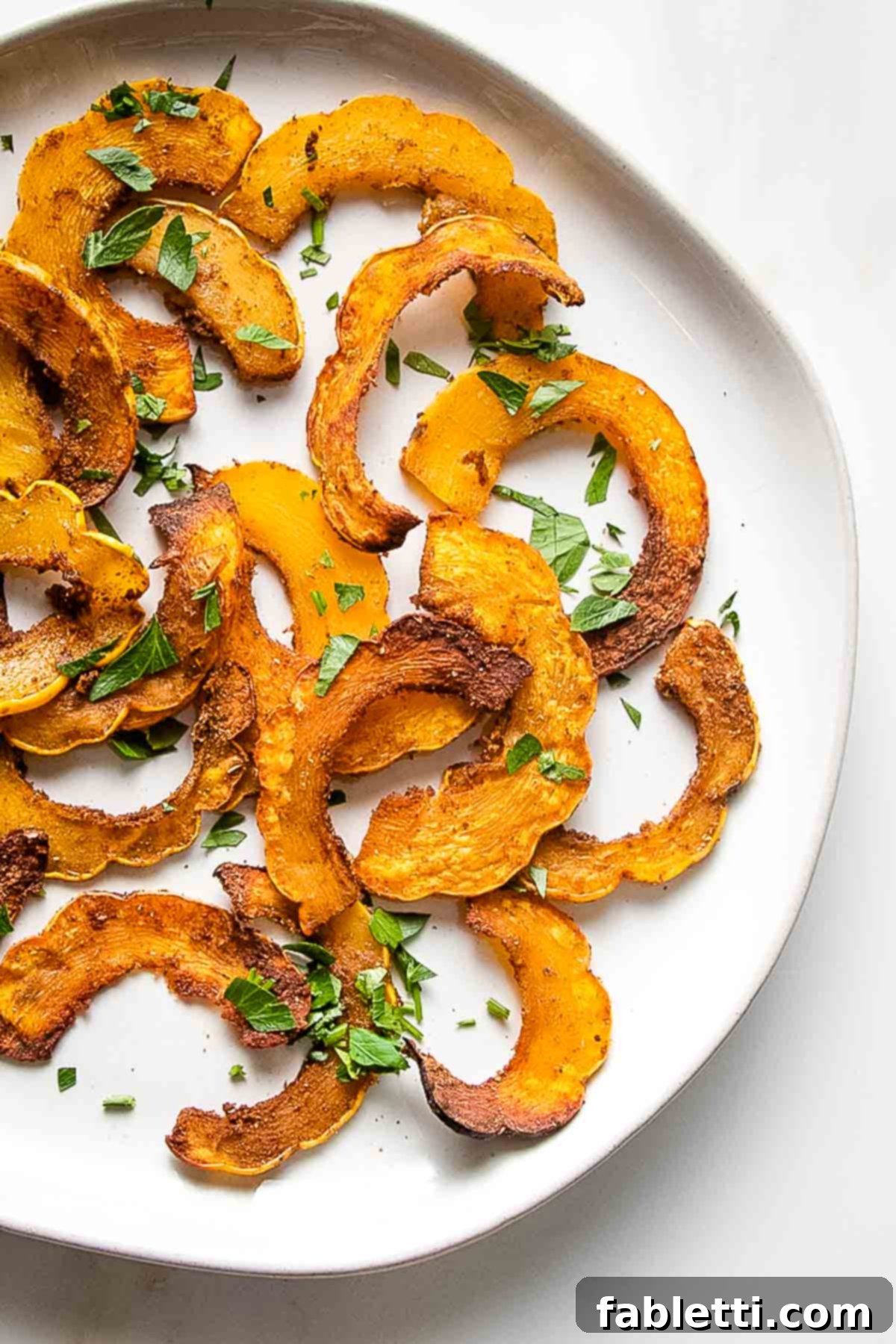 Golden Roasted Delicata Squash 11 Roasted delicata squash in thin slices with spices and fresh herbs.