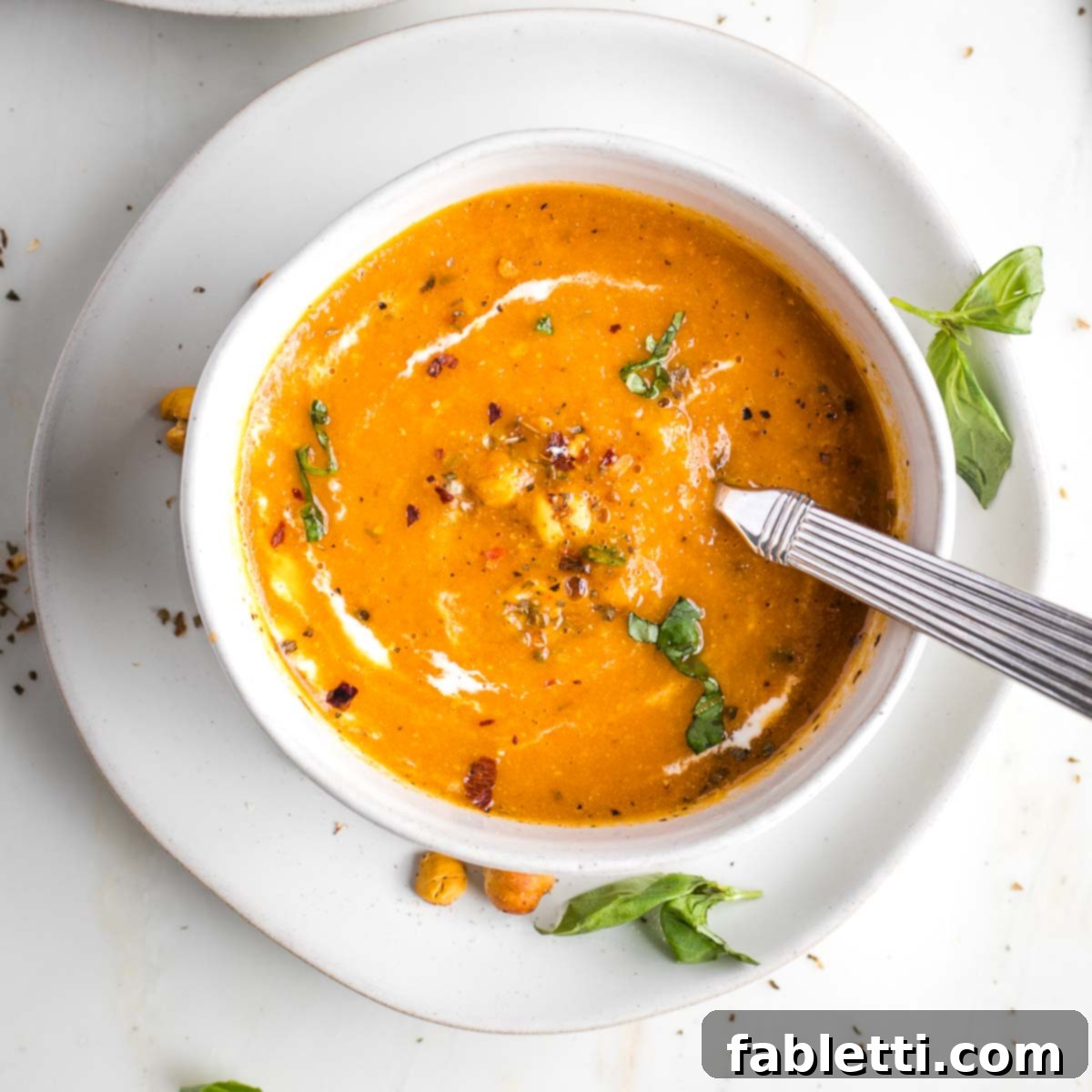 Creamy Vegan Tomato Soup 12 A swirl of cashew cream garnishing a bowl of dairy-free tomato soup.