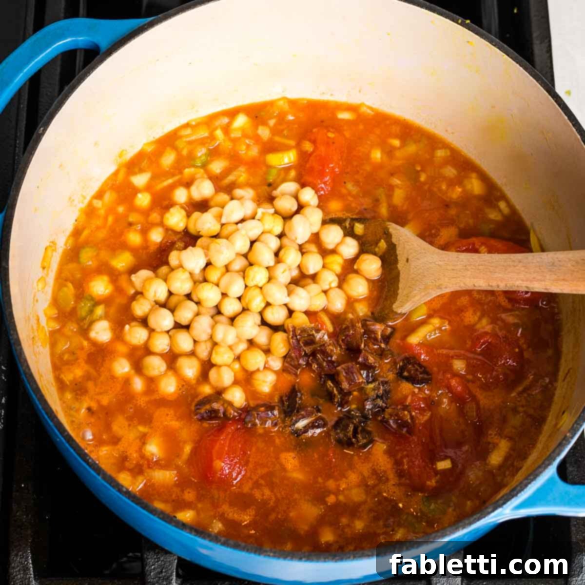 Creamy Vegan Tomato Soup 9 Tomato based soup with chickpeas and chopped dates on top, before blending.