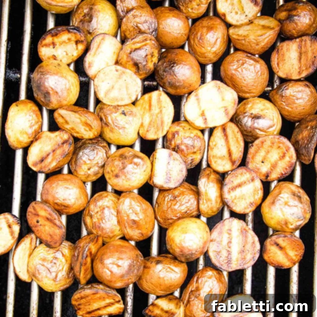 Smoky Grilled Potato Salad 6 Potatoes on the BBQ, browned and with grill marks.