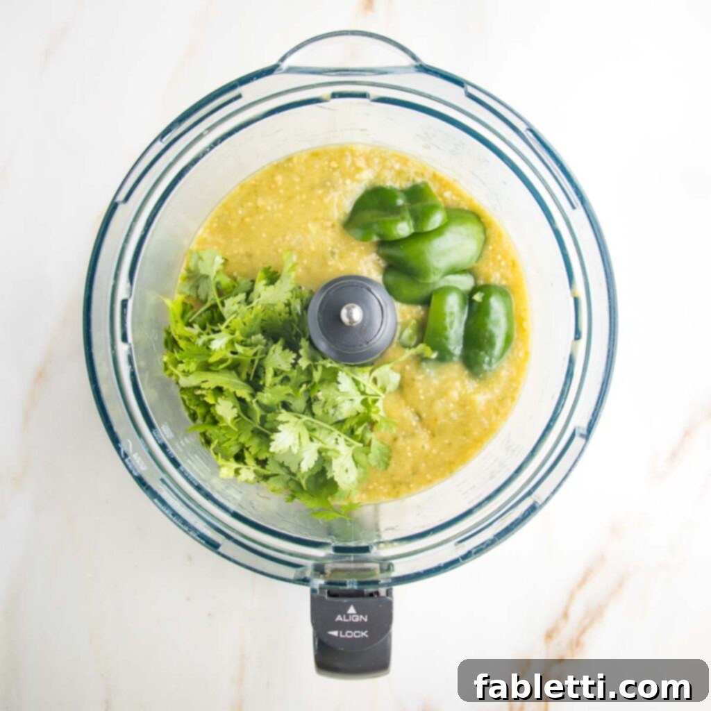 Fire-Kissed Tomatillo Salsa Verde 10 Fresh cilantro and lime wedges next to a bowl of roasted tomatillo salsa.