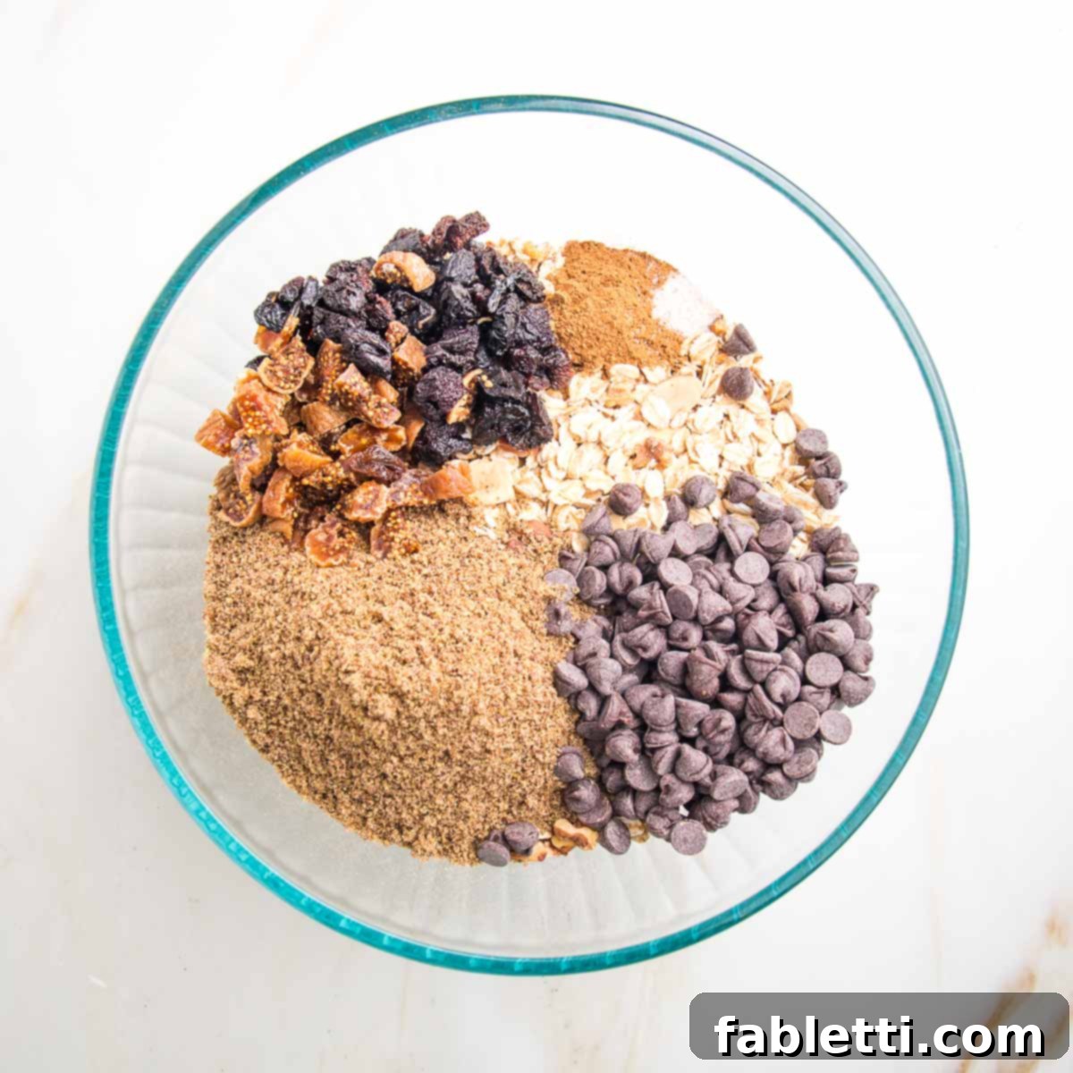 Golden Baked Granola Bites 8 Chocolate chips, flax, raisins, and cinnamon added to a bowl of cooled oats and nuts.