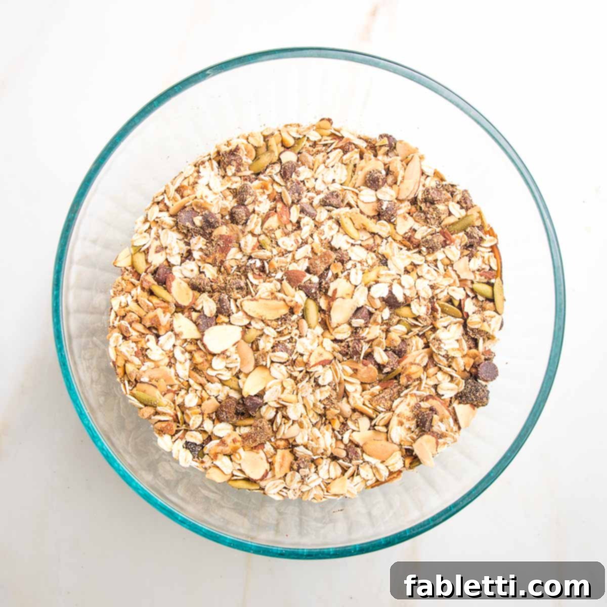 Golden Baked Granola Bites 9 Mixture of oats, nuts, seeds, cinnamon, raisins, and chocolate chips, well combined.