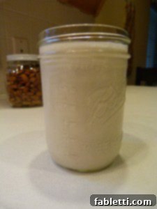 Freshly Crafted Almond Milk 5 Mason jar filled with almond milk.