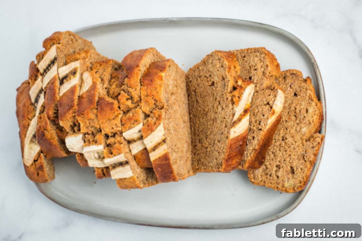 Thick slices of Maple Miso Banana Bread arranged neatly on a serving plate.