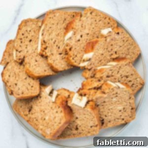 Slices of Maple Miso Banana Bread, artfully arranged on a platter, showcasing its golden crust and moist interior.