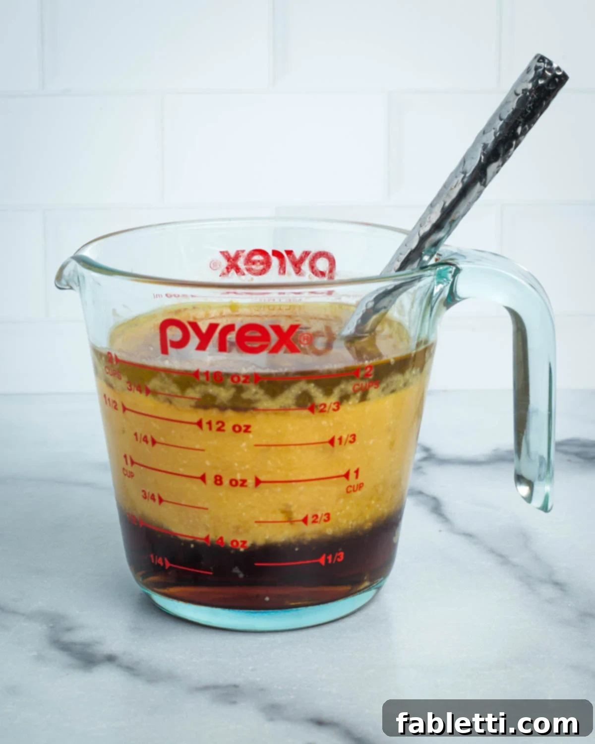 Olive oil, maple syrup, and vanilla extract are added to the wet ingredients, which are then mixed until uniform.