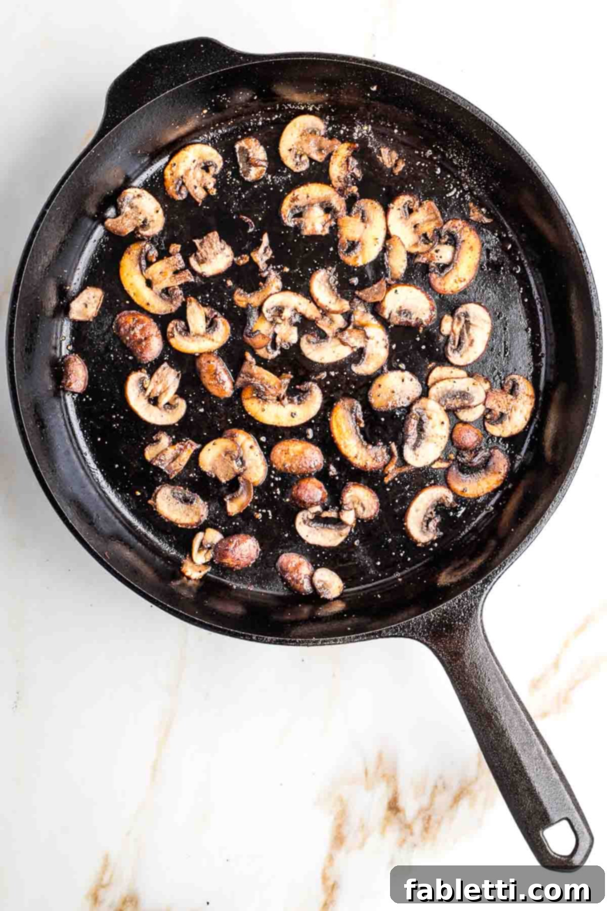 Velvety Plant-Based Broccoli Soup 16 Sliced portobello mushrooms in a cast iron skillet.