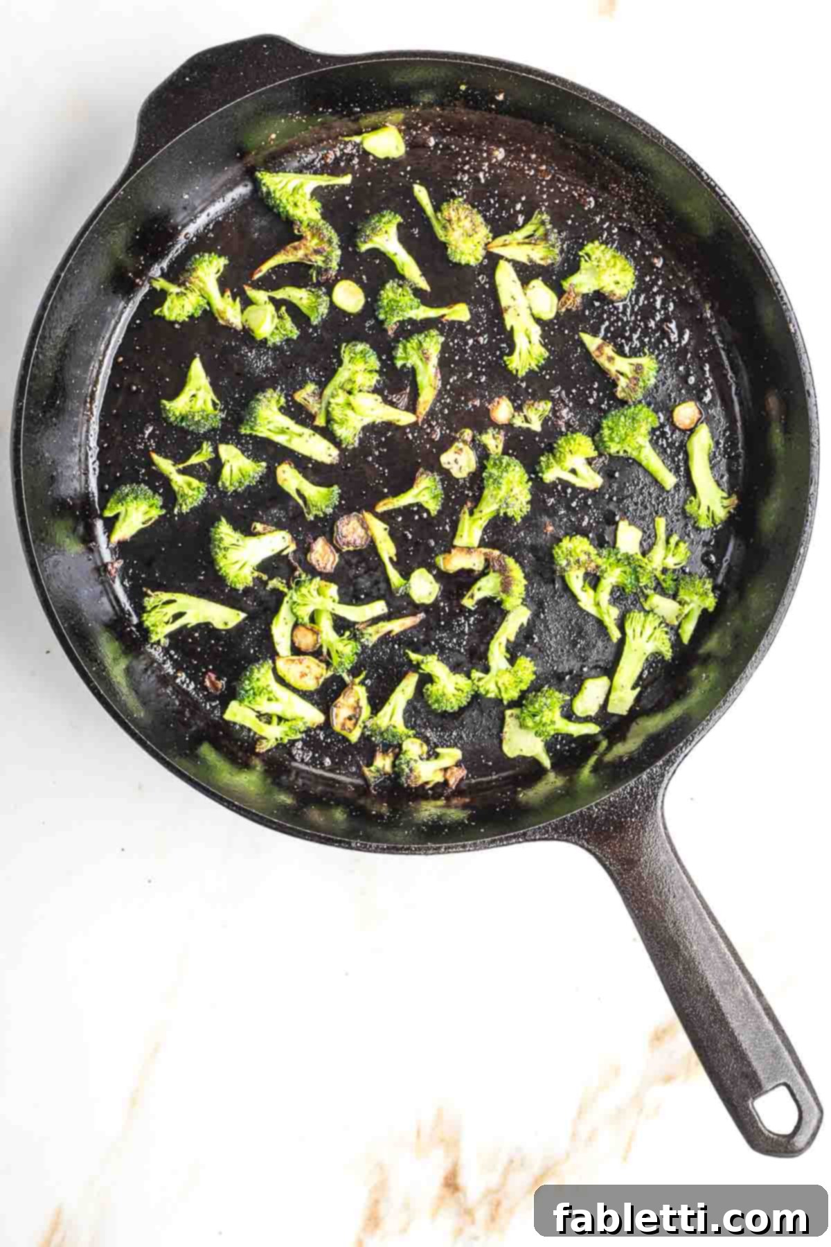 Velvety Plant-Based Broccoli Soup 17 Broccoli florets and diced stems in a cast iron skillet.