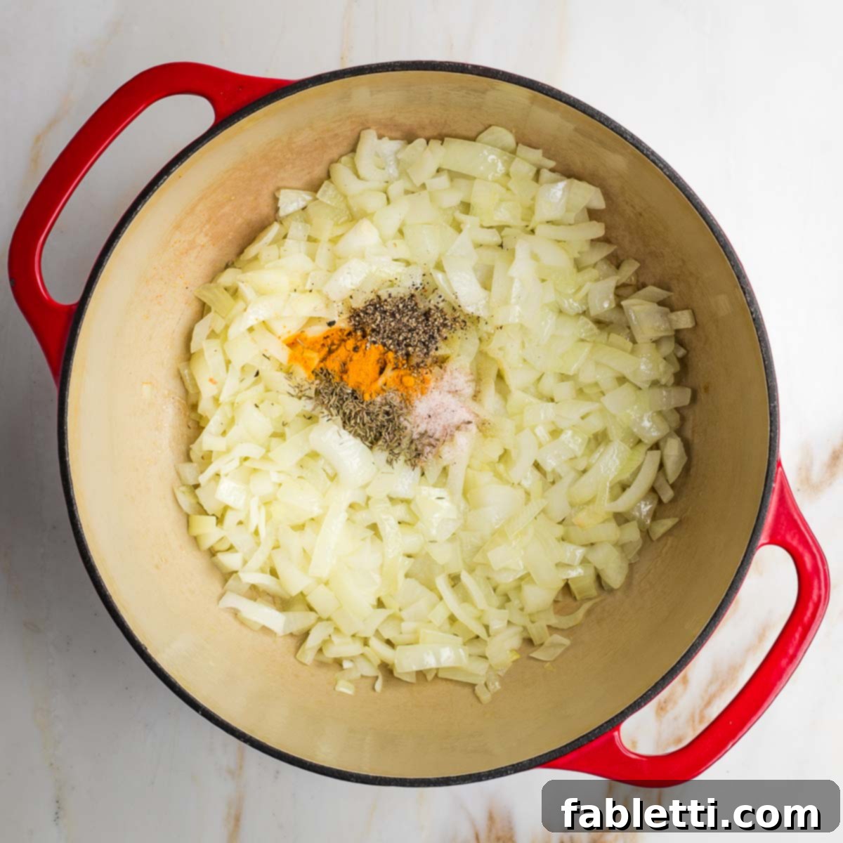 Velvety Plant-Based Broccoli Soup 7 Dutch oven with sauteed onions plus spices.