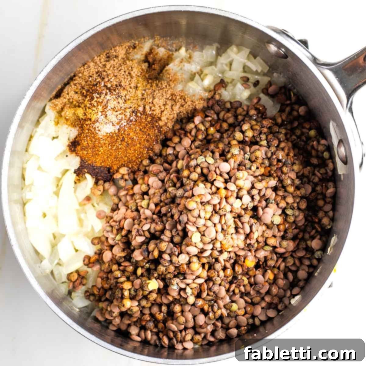 Hearty Vegan Lentil Tacos 5 Rinsed lentils and spices added to the sautéed onion and garlic mixture.