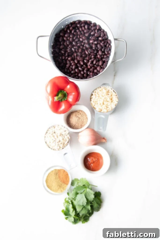 Plant-Powered Black Bean Burgers 4 An array of fresh, vibrant ingredients for black bean burgers: black beans, red pepper, cooked rice, oats, fresh cilantro, flaxseed, shallot, sriracha, and aromatic spices.
