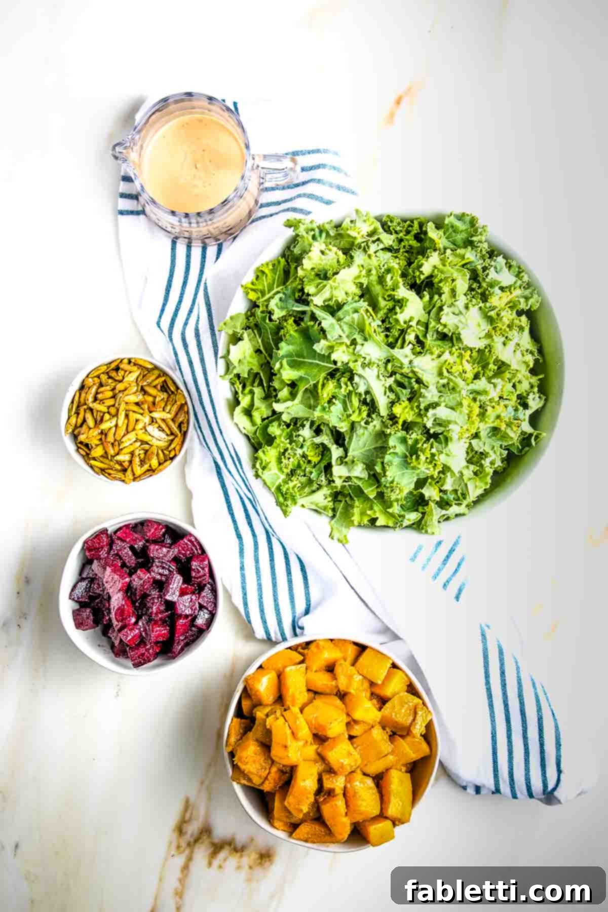 Vibrant Butternut Beetroot Medley 14 Bowls with massaged kale, roasted squash, roasted beets, toasted pepitas and a creamy dressing.