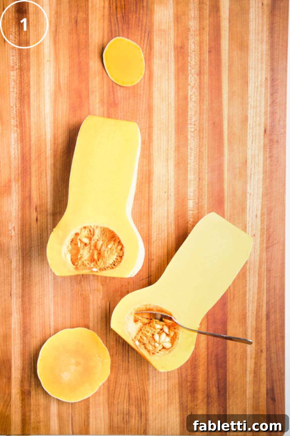 Vibrant Butternut Beetroot Medley 5 Butternut squash, cut into lengthwise halves. A grapefruit spoon is scooping out the seeds.