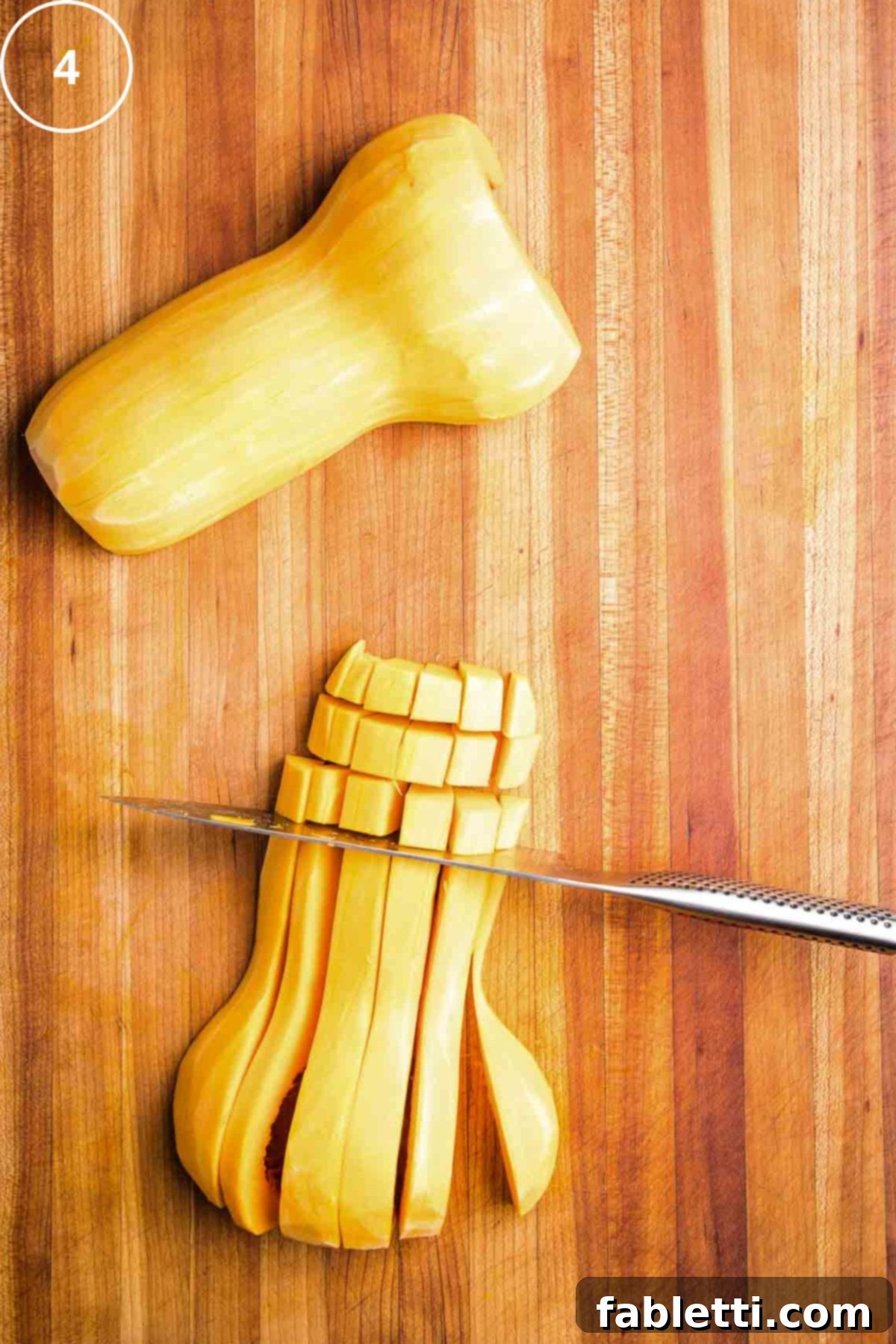 Vibrant Butternut Beetroot Medley 8 Chef's knife cutting through long strips of butternut squash to create ½ inch cubes.