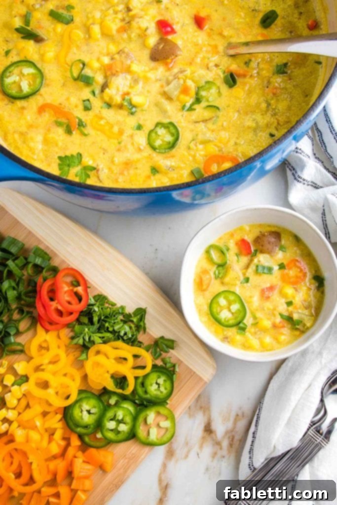 A close-up of a rustic bowl filled with creamy vegan corn chowder, generously topped with a vibrant array of fresh garnishes including thinly sliced jalapeños, chopped fresh cilantro, and a sprinkle of microgreens, adding color and fresh texture.