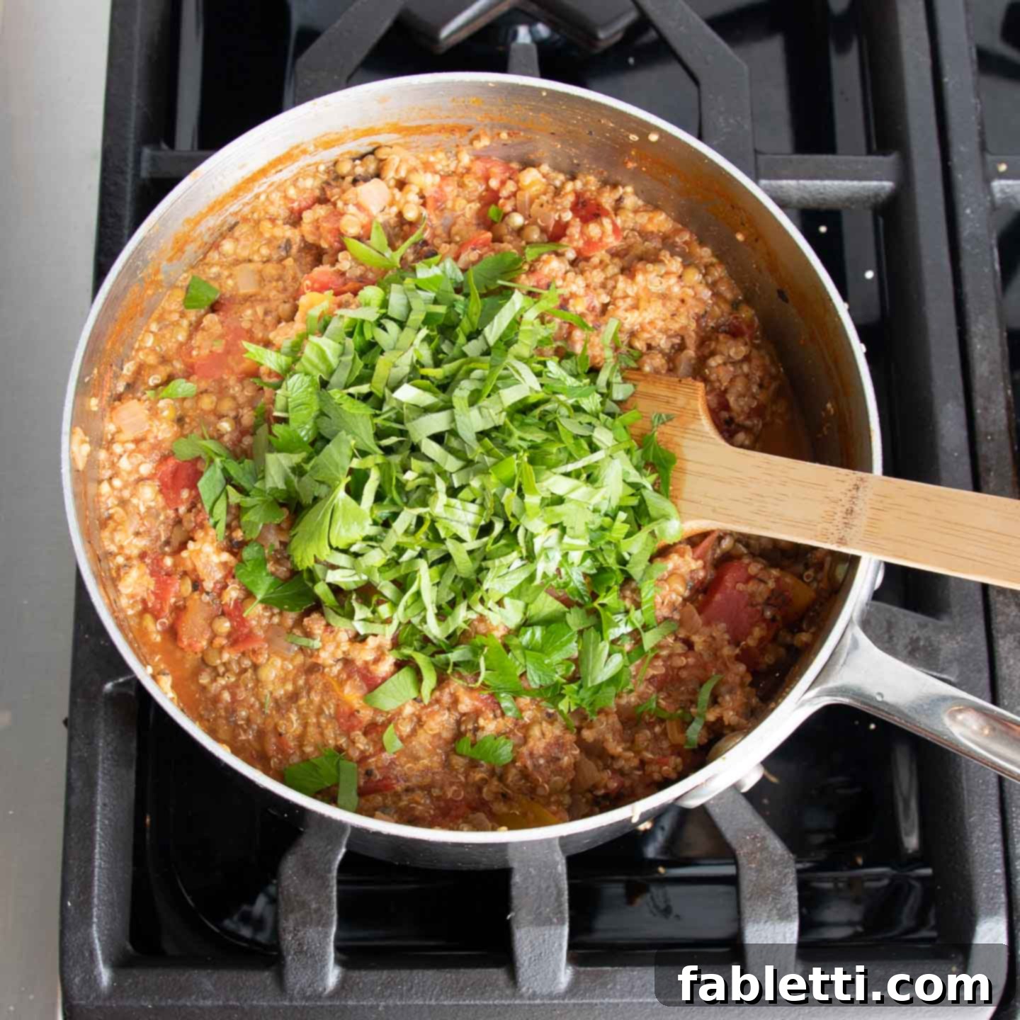 Hearty Vegan Lentil Stuffed Peppers 11 Fresh herbs being mixed into the cooked quinoa and lentil stuffing.