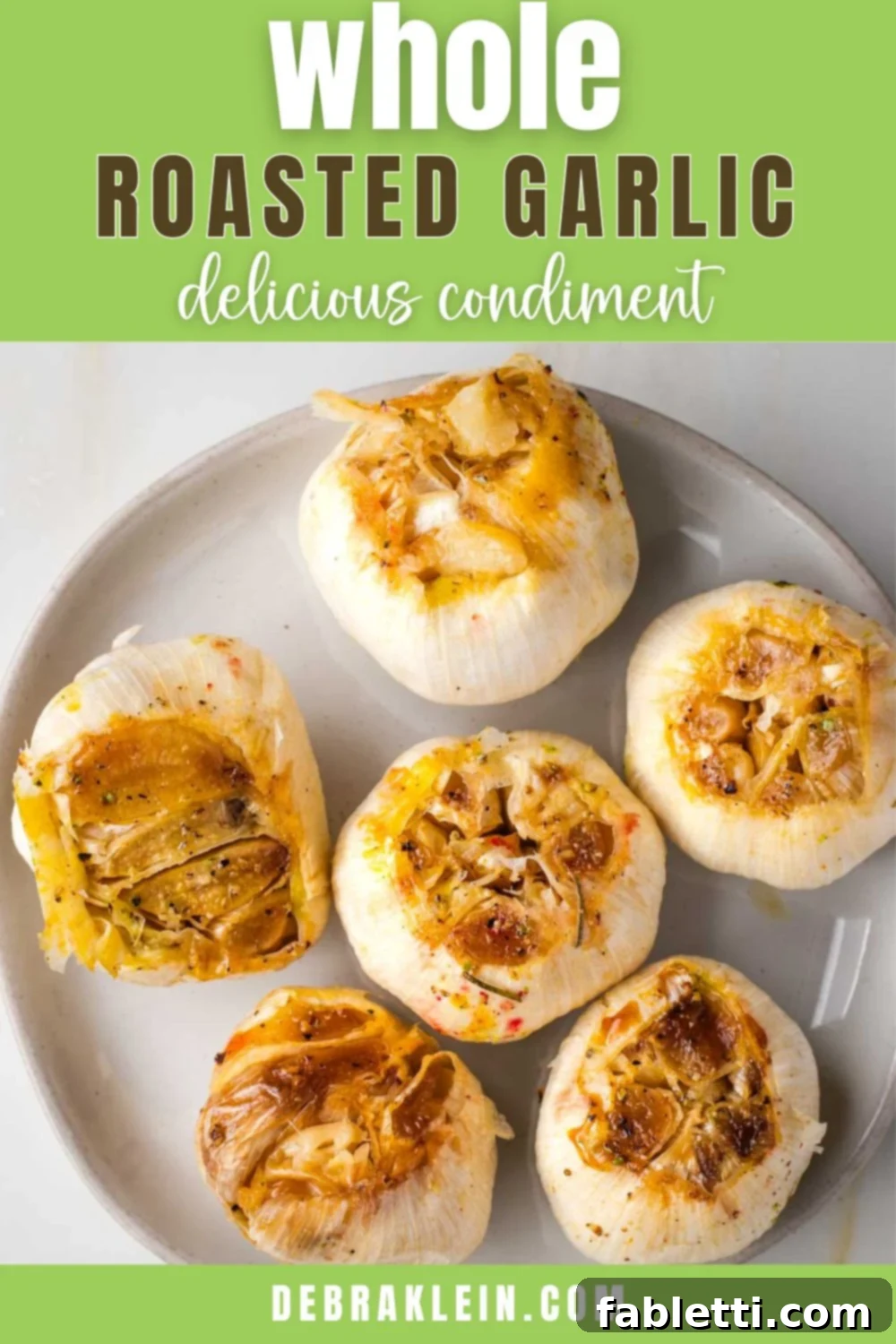 Sweet Creamy Oven Roasted Garlic 13 A beautiful plate full of golden, whole roasted heads of garlic, with the text 'Whole Roasted Garlic' overlaid.