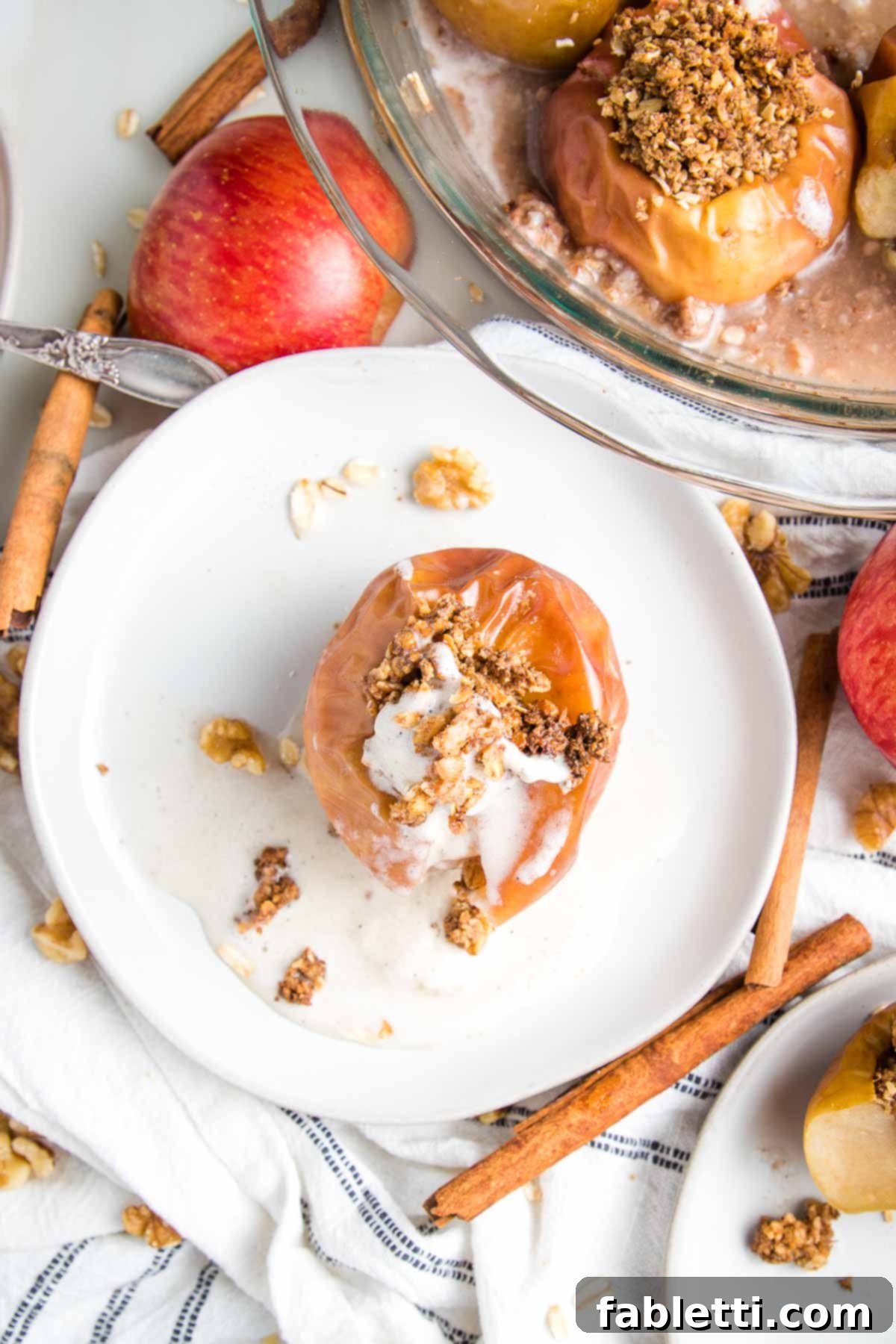 Naturally Sweet Dairy-Free Baked Apples 3 Whole baked apple, stuffed with oatmeal mixture and topped with a scoop of dairy-free ice cream, showcasing the rich, spiced filling and comforting presentation.