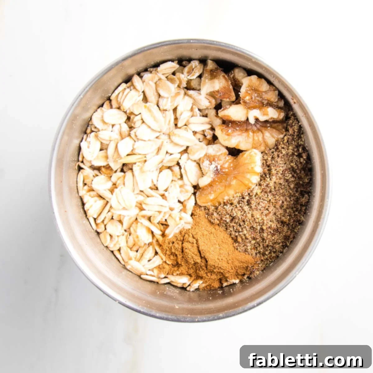 Naturally Sweet Dairy-Free Baked Apples 10 Rolled oats, walnuts, ground flax seeds, and cinnamon in a spice grinder, ready to be processed into the aromatic filling for baked apples.