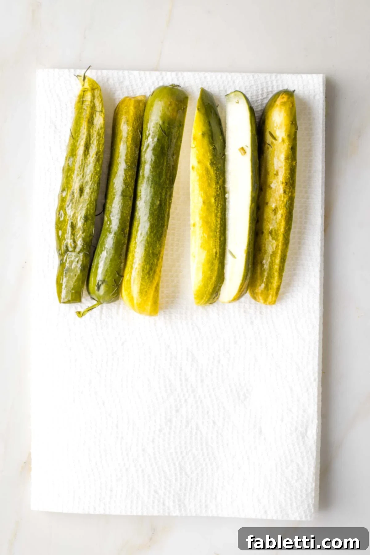Zesty Israeli Corn and Pickle Salad 4 Pickle spears laid out evenly on a paper towel to drain excess liquid before dicing.