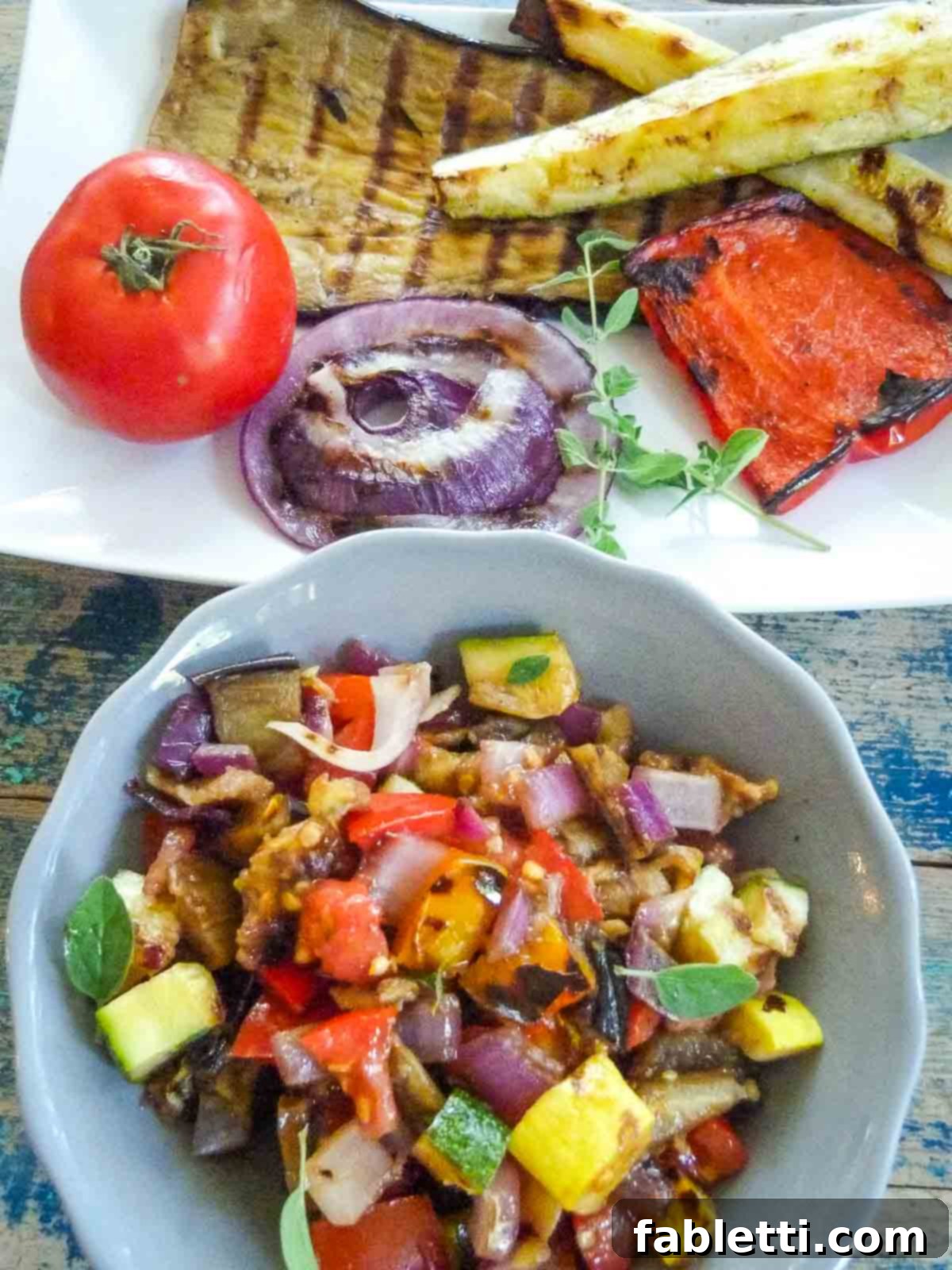 Smoky Grilled Ratatouille Salad 8 A platter of whole roasted veggies next to a bowl of those same veggies chopped into bite-sized pieces for salad.