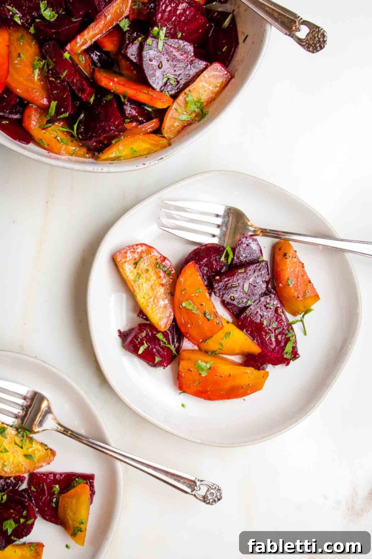 Balsamic Roasted Beet Salad 2 White bowl filled with golden and red beets, cut into wedges, with a vinaigrette and chopped fresh parsley. Roasted beet salad with balsamic vinaigrette.