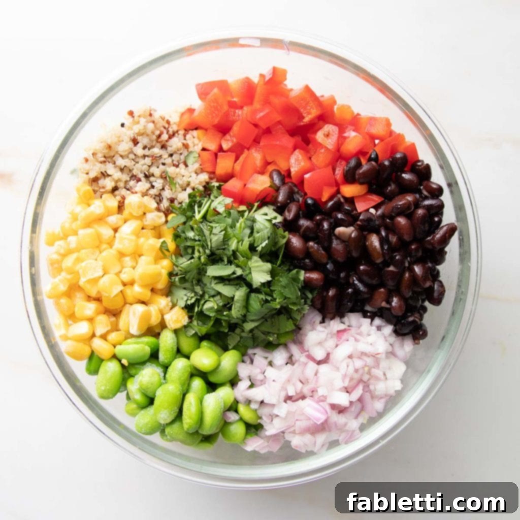 Zesty Southwest Quinoa Salad 7 Quinoa, beans, edamame, corn, bell peppers and onions in a bowl.