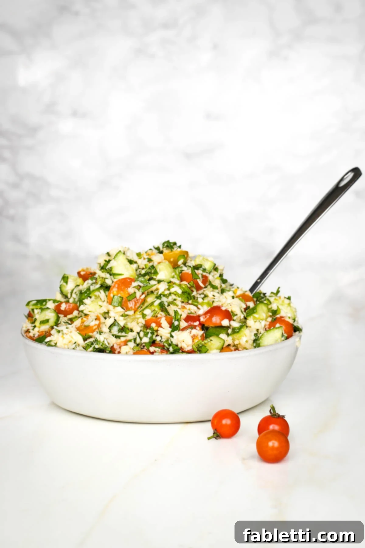Sweet Parsnip Gluten-Free Tabbouleh 2 Bowl of colorful tabbouleh with tomatoes, fresh herbs, and scallions.