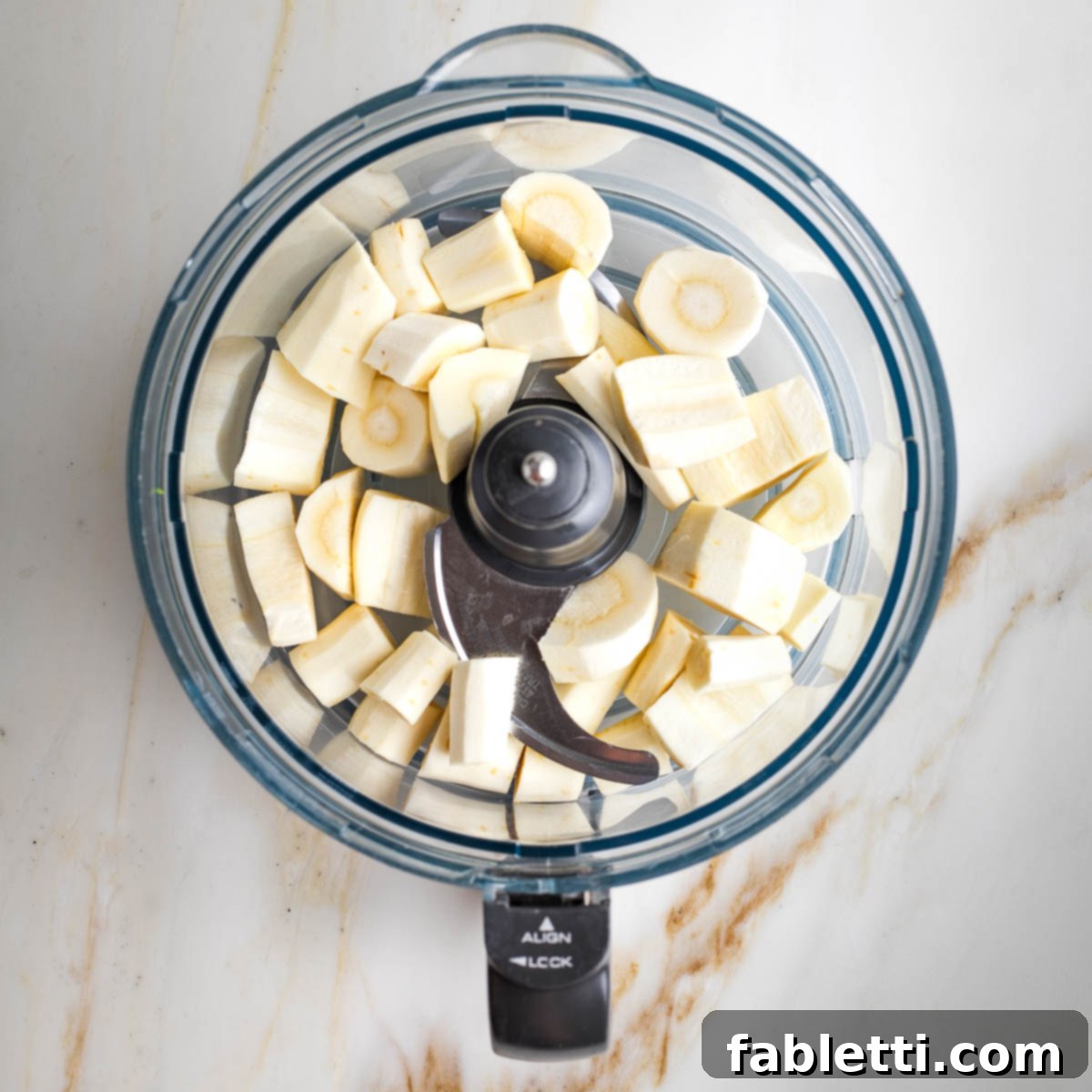 Sweet Parsnip Gluten-Free Tabbouleh 9 Chunks of parsnips in the bowl of a food processor.