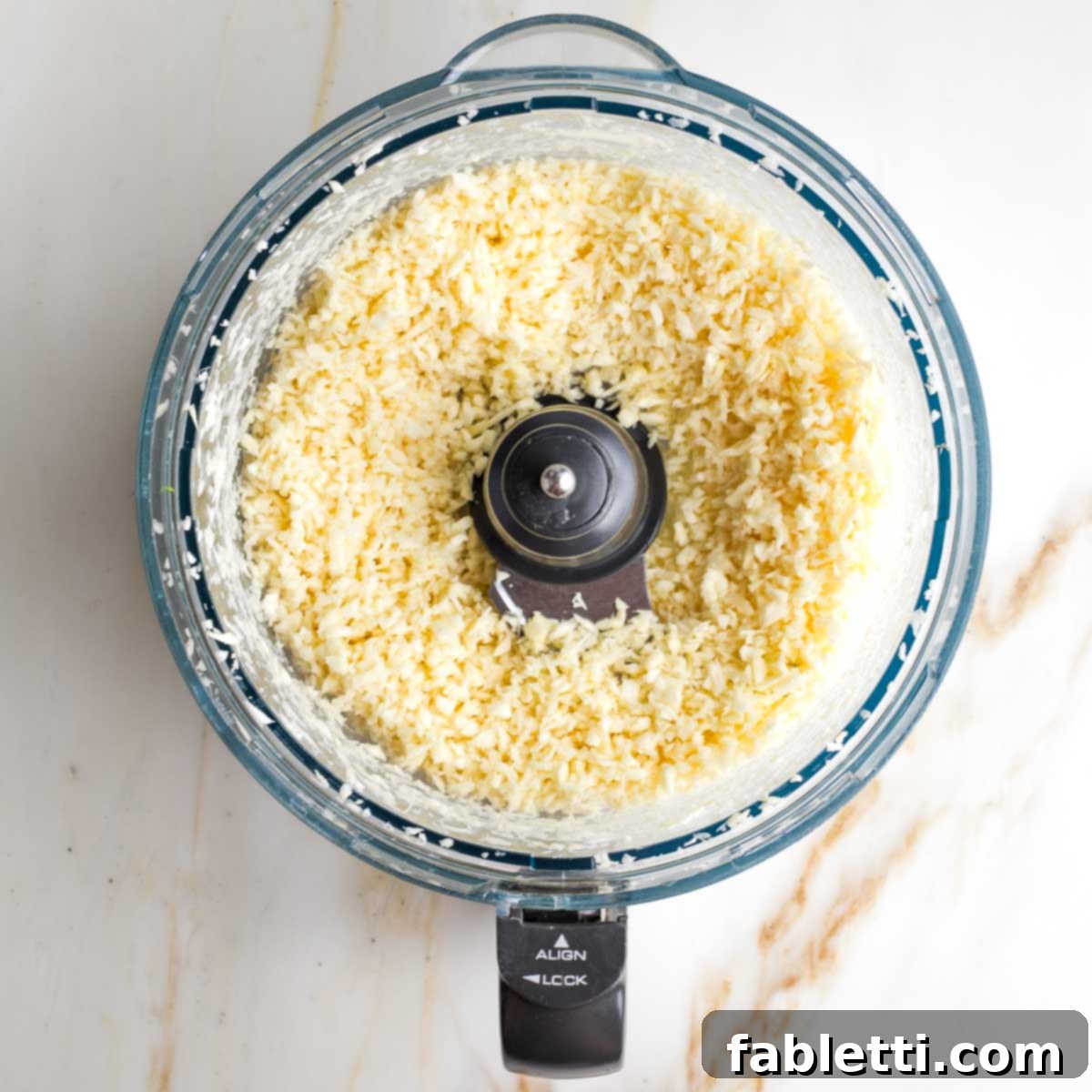 Sweet Parsnip Gluten-Free Tabbouleh 10 Tiny pieces of parsnips in the bowl of a food processor.